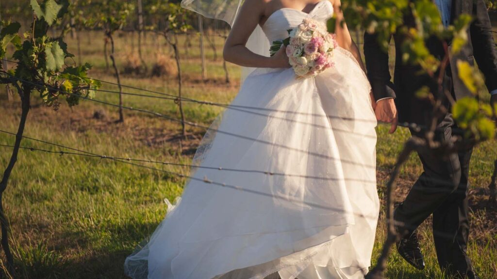 Sirromet Wedding - walking through vines