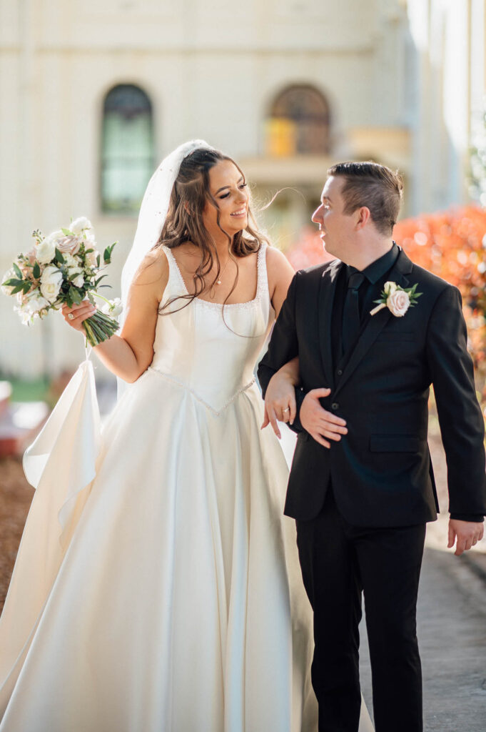 All Hallows Chapel Wedding - Bride & groom walking